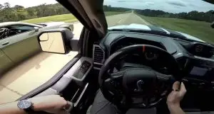 Green 2020 Dodge Hellcat passes white 2020 Shelby F150 in drag race